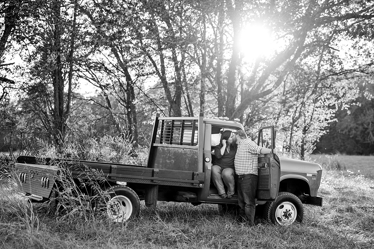 Black and white photo of vintage truck in a field for engagement photos