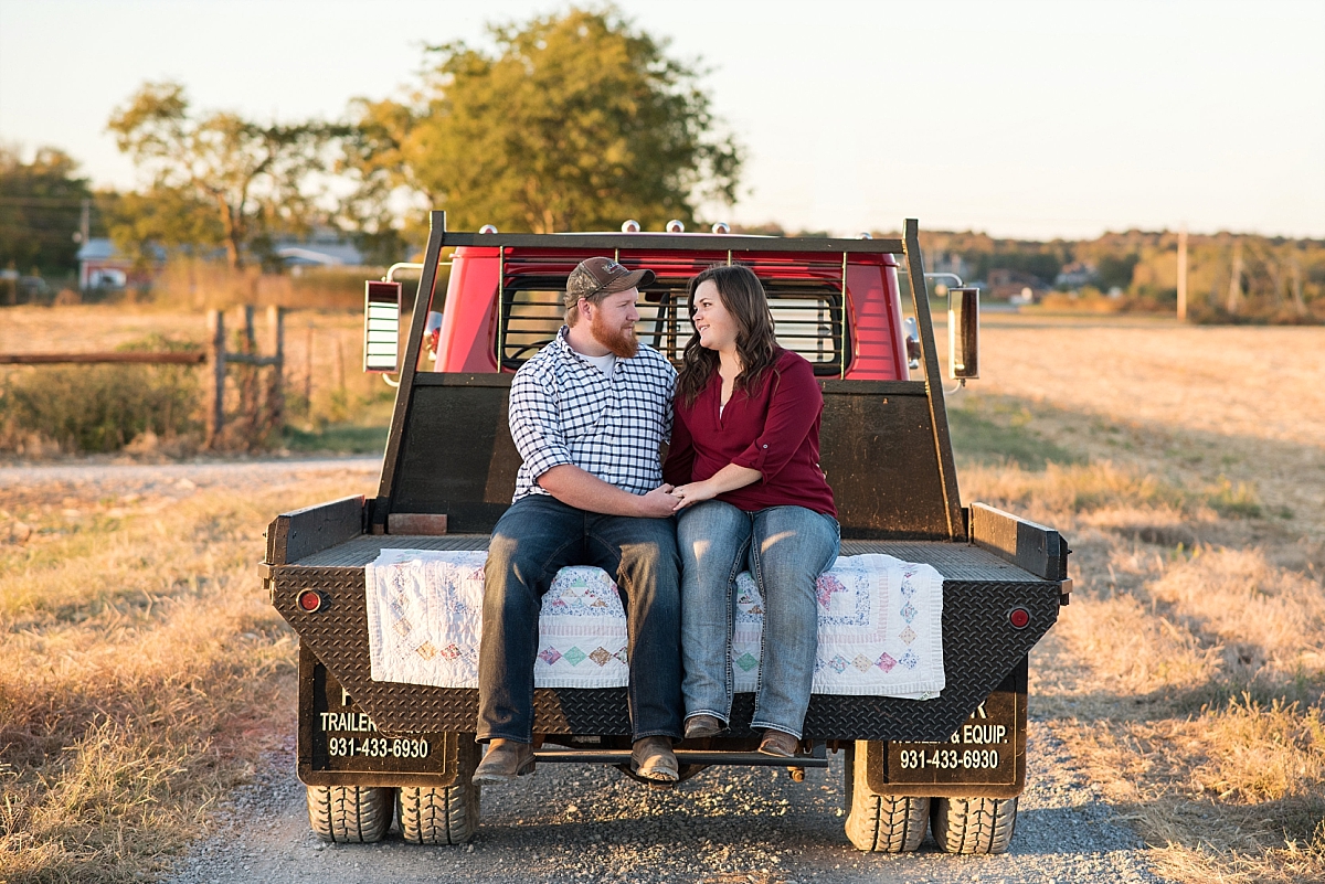 Engagement photo of antique red truck on a country road