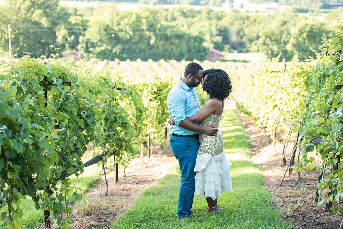 Wife and husband standing in vineyard for anniversary photos