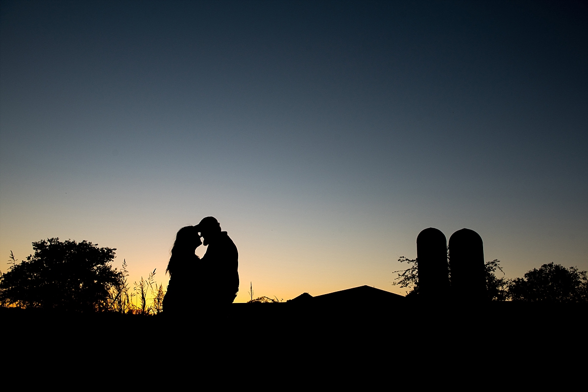 Silhouette sunset engagement photos on a farm