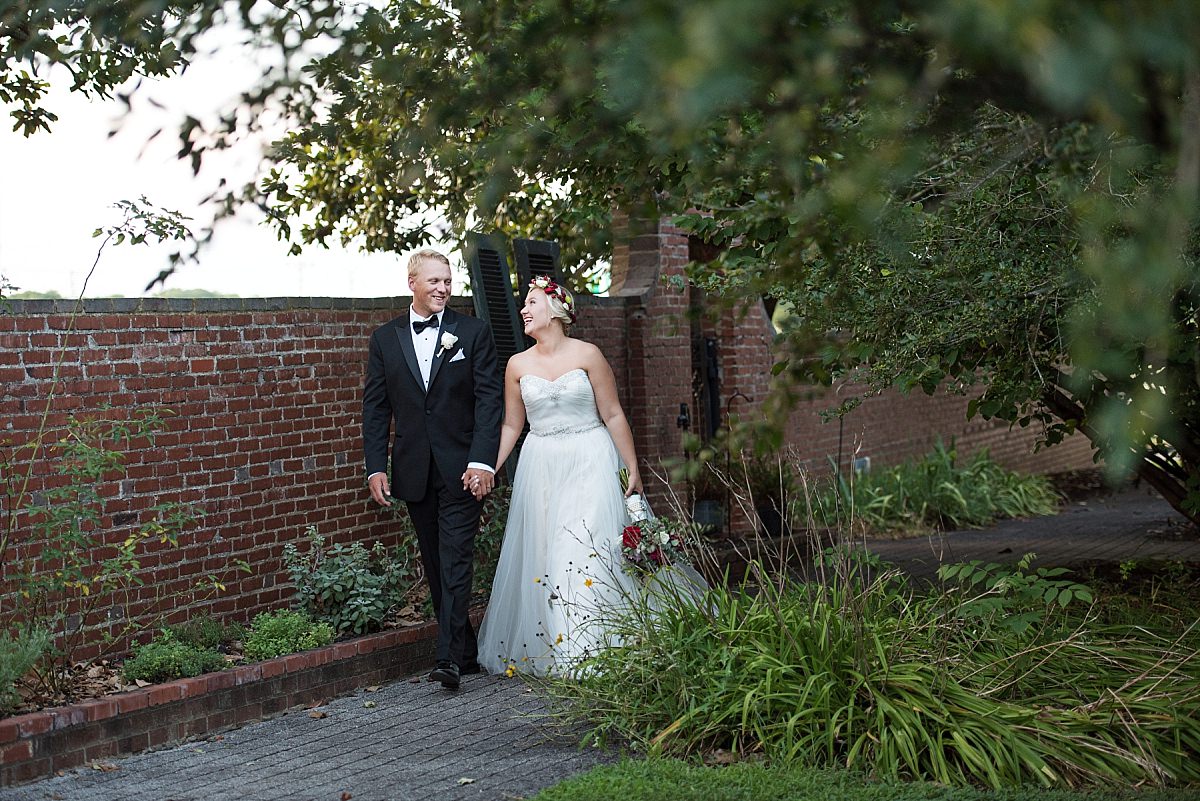 Walking through courtyard at Rippavilla Plantation bride and groom together