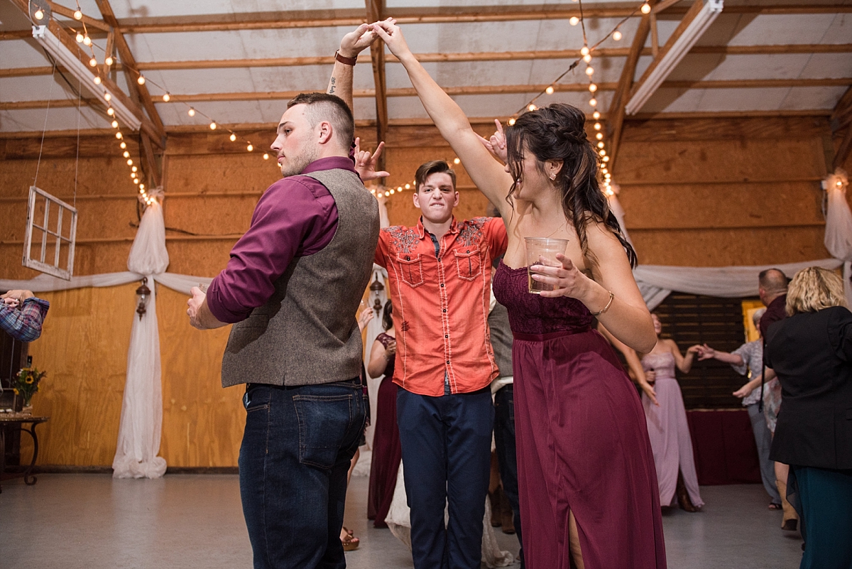 Bridesmaids and groomsmen dancing together during reception