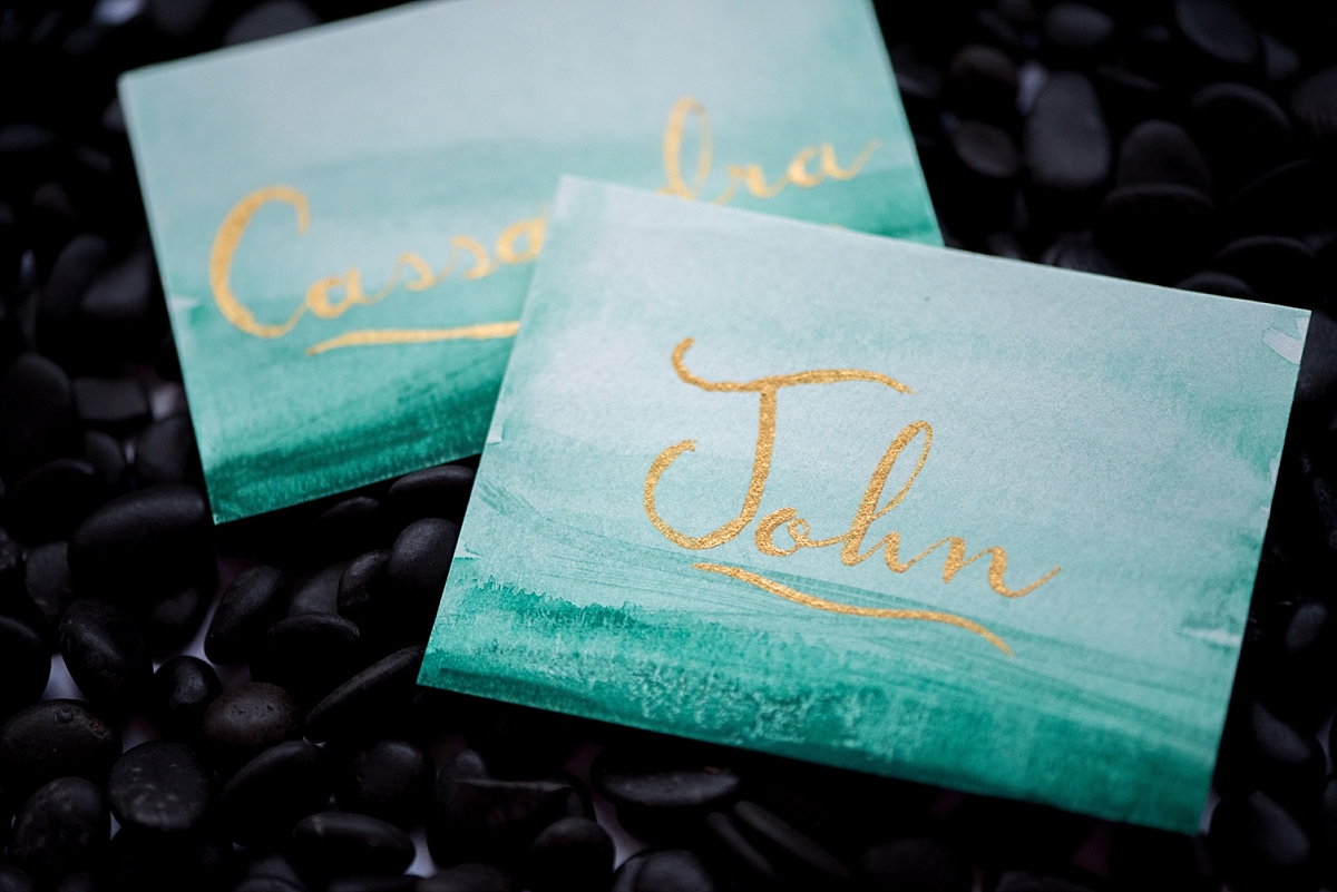 Hunter green ombre seating cards with gold calligraphy