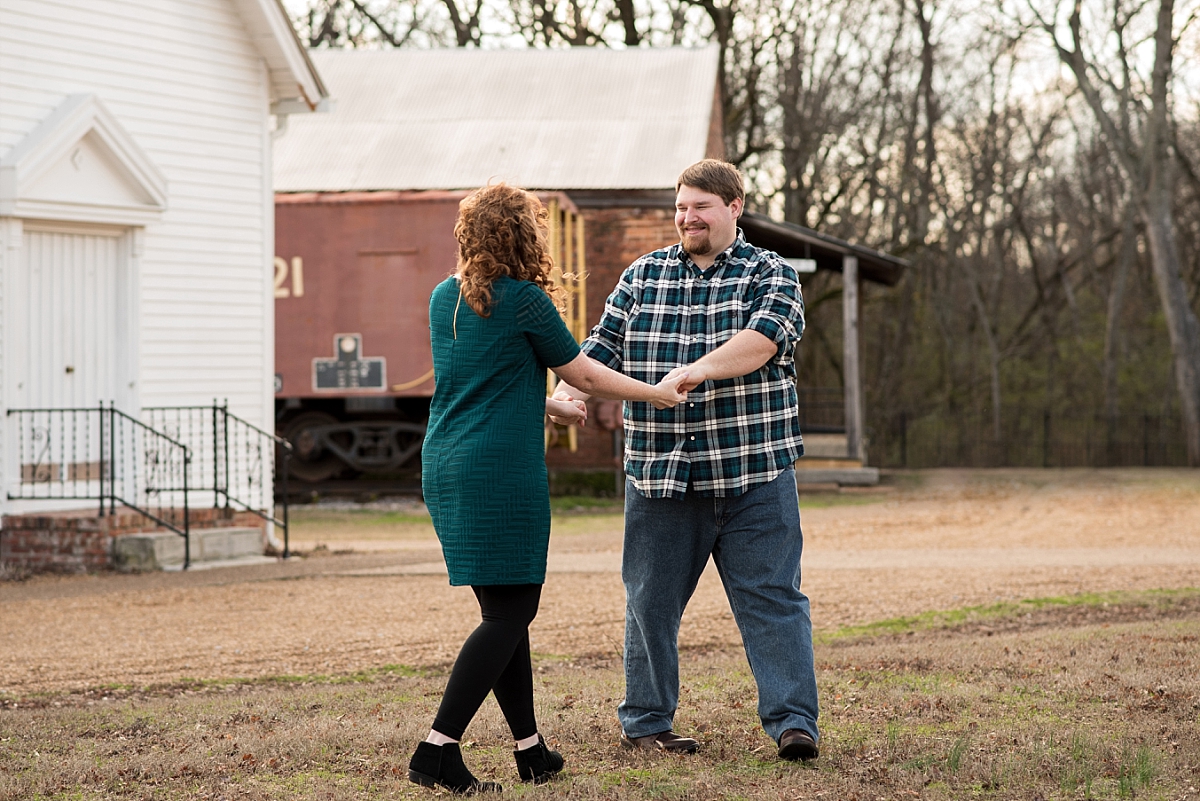 Bride and groom dancing happily during engagement pictures