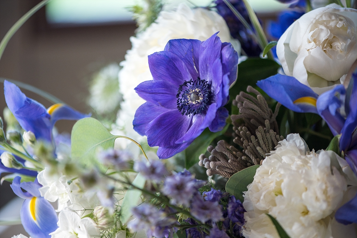 Blue anemone flowers with lilacs and white hydrangea flower centerpieces
