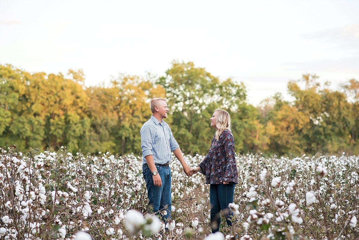Couple dancing in cotton field during anniversary photos