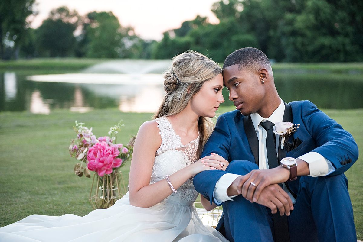 lake at country club during sunset with bride and groom