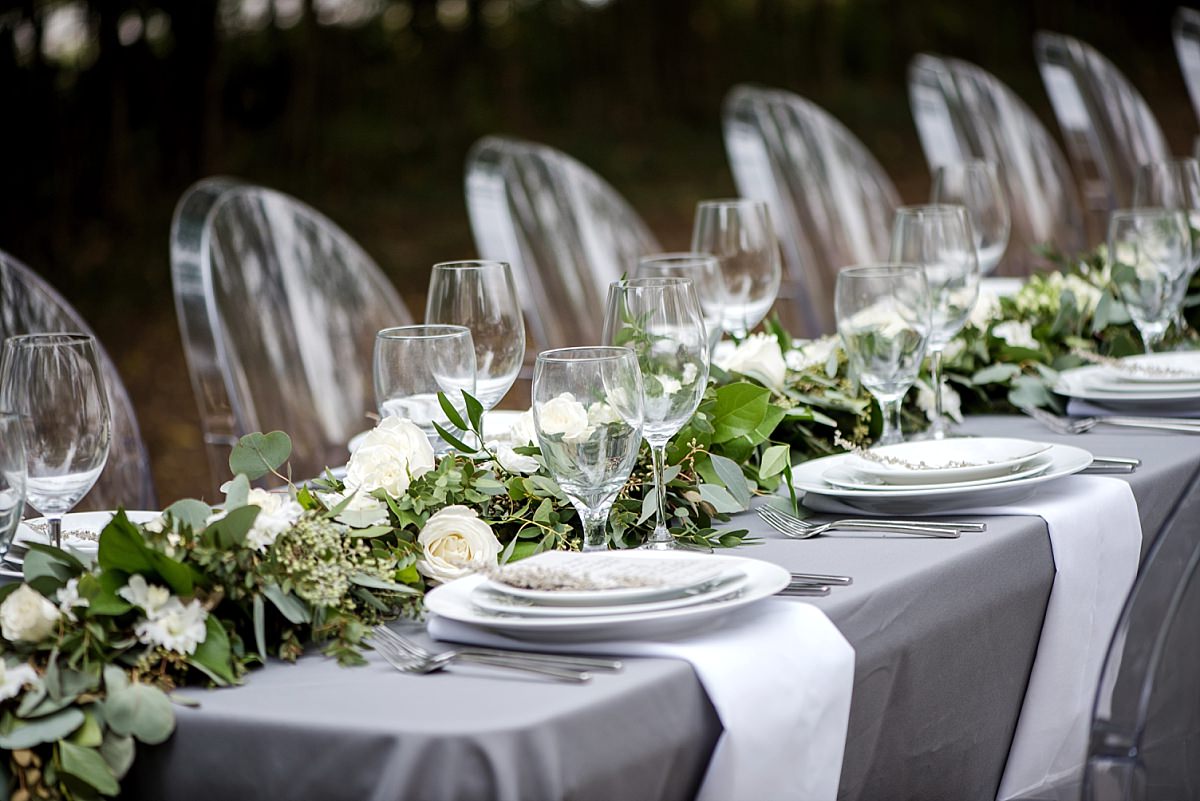 Reception table design of greenery table runner and ivory flowers