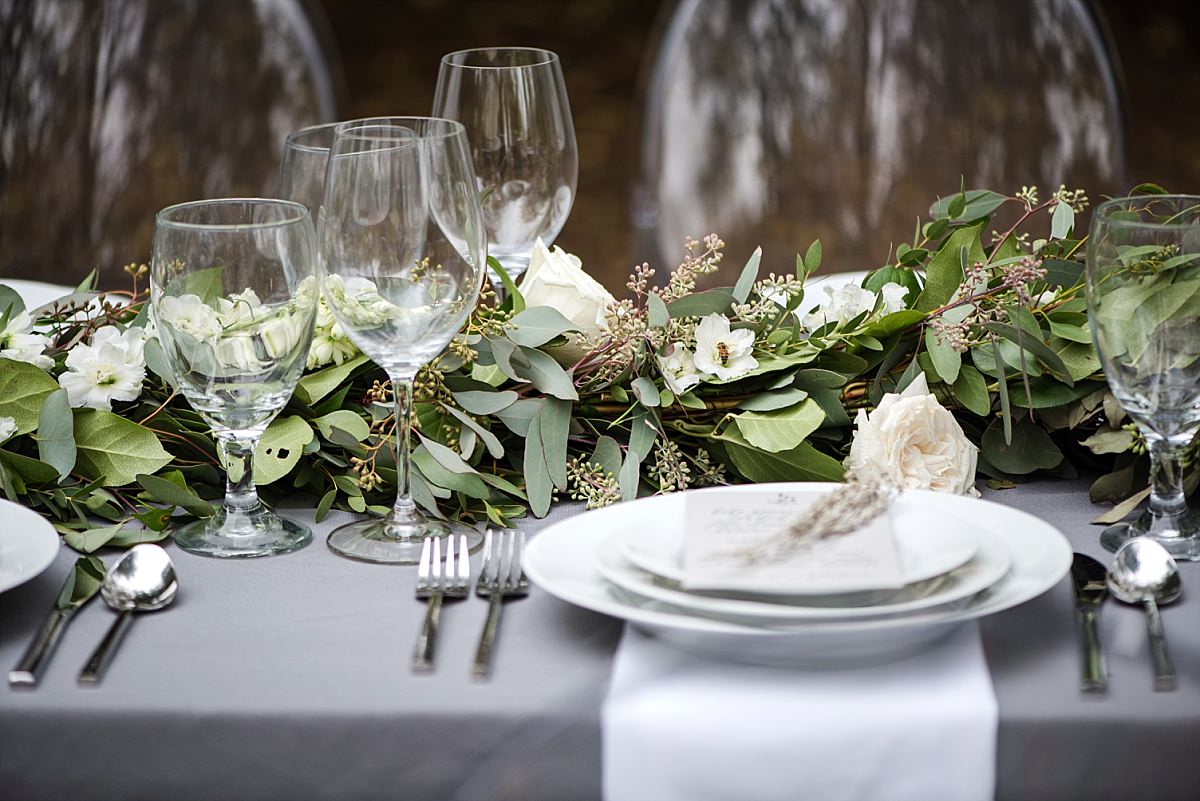 Ivory and greenery table runner on grey tablecloth