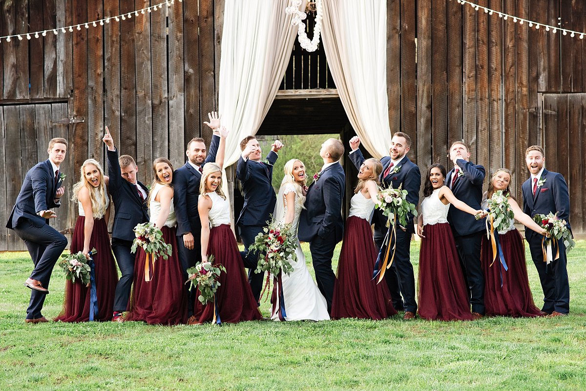 Fun group wedding party photo outside of barn