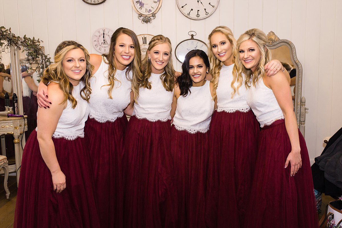Bridesmaids in burgundy tulle skirts and lace tops