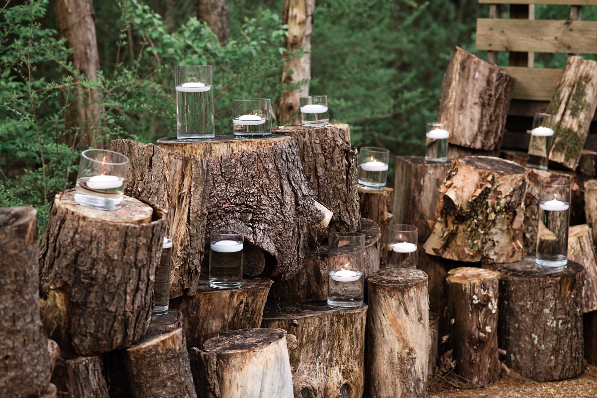 Tree stumps and candles in vases