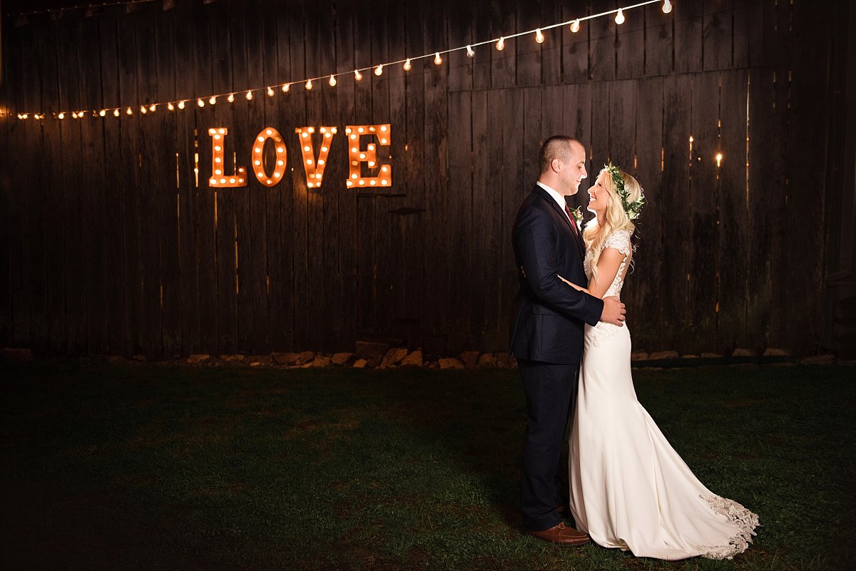 Dakewoof Farm love sign at night with bride and groom