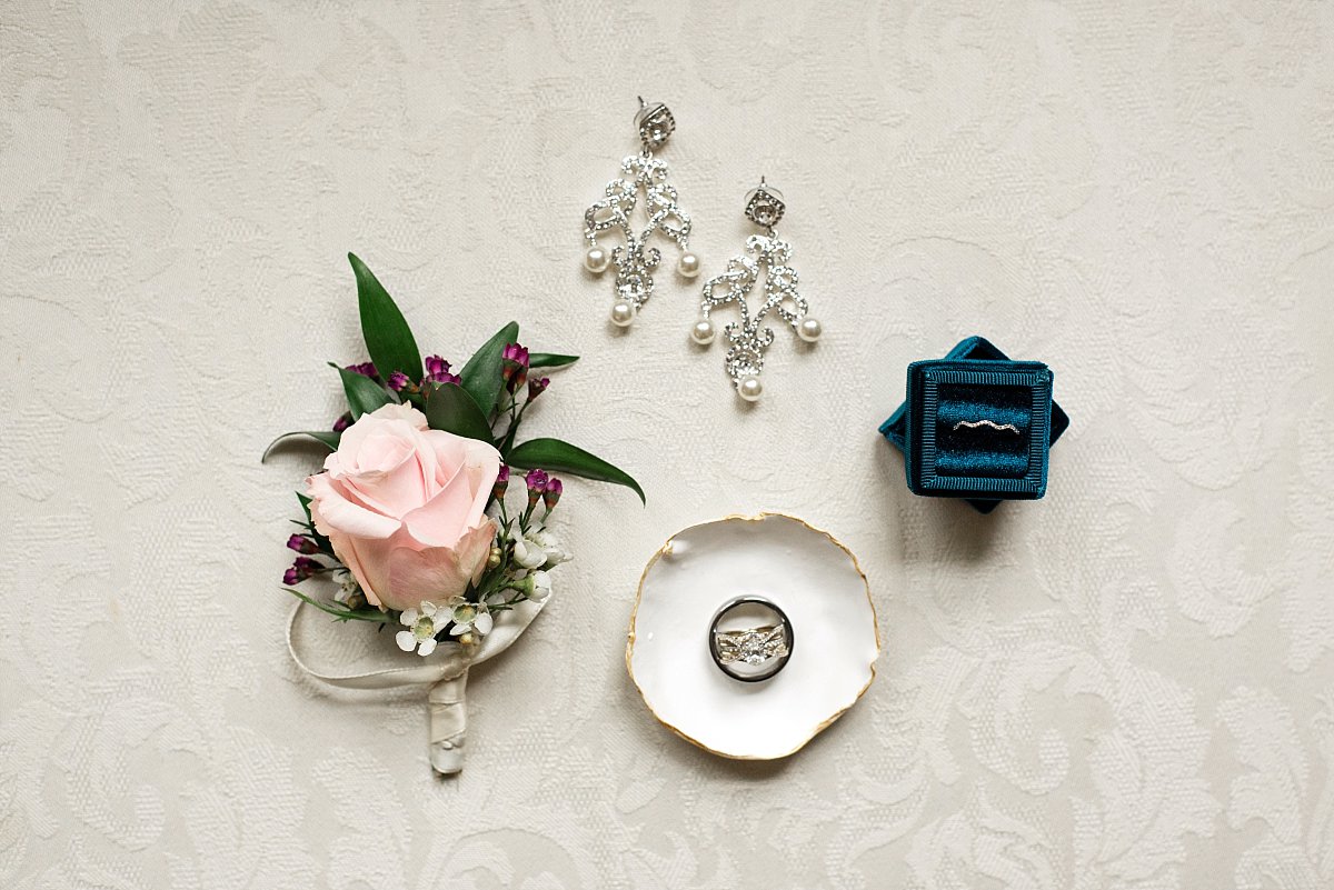 Layflat of bride jewelry and groom boutonniere