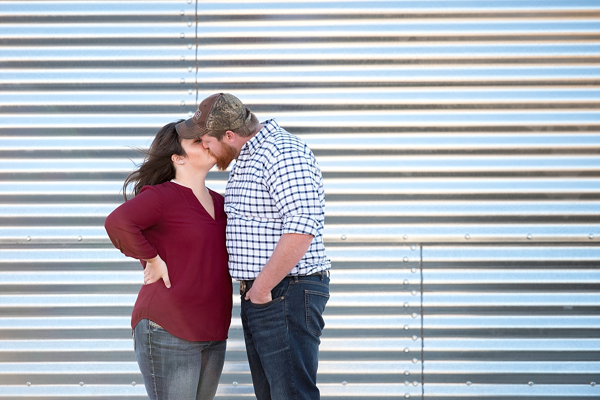 Couple kissing infront of a grain silo