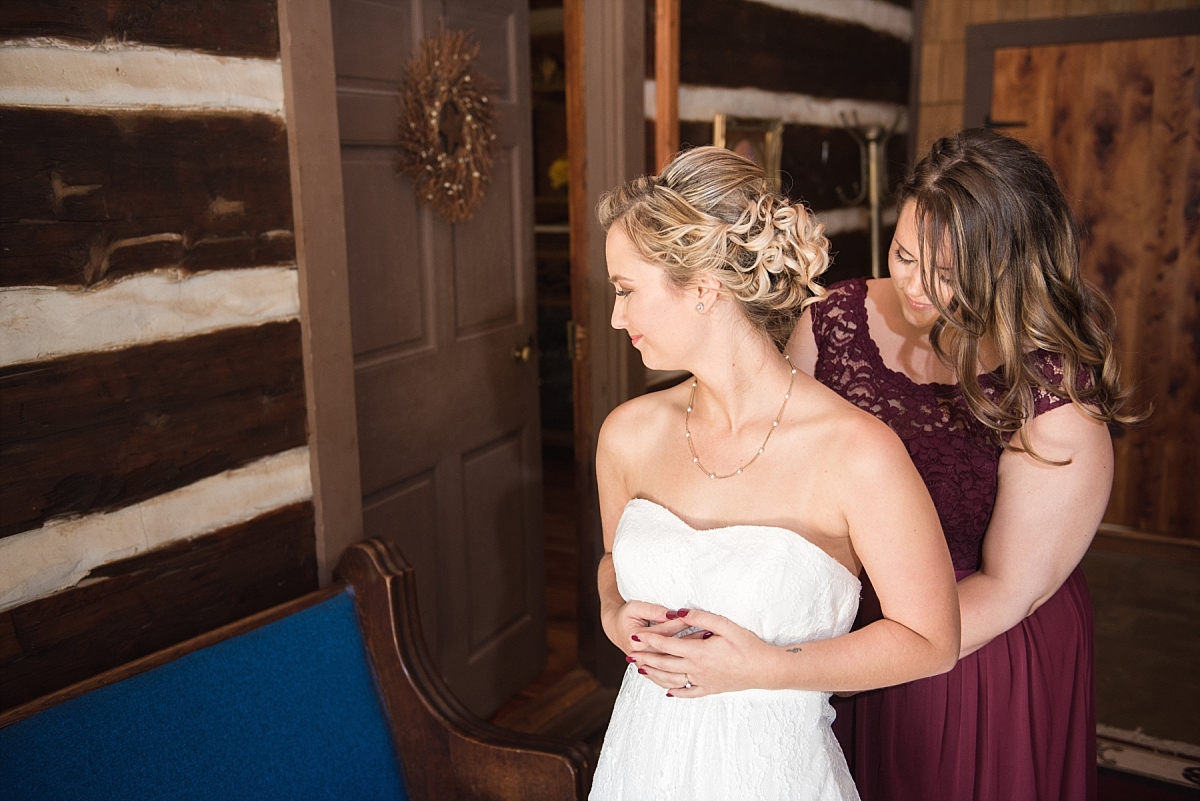 Bride getting ready with maid of honor in historic plantation