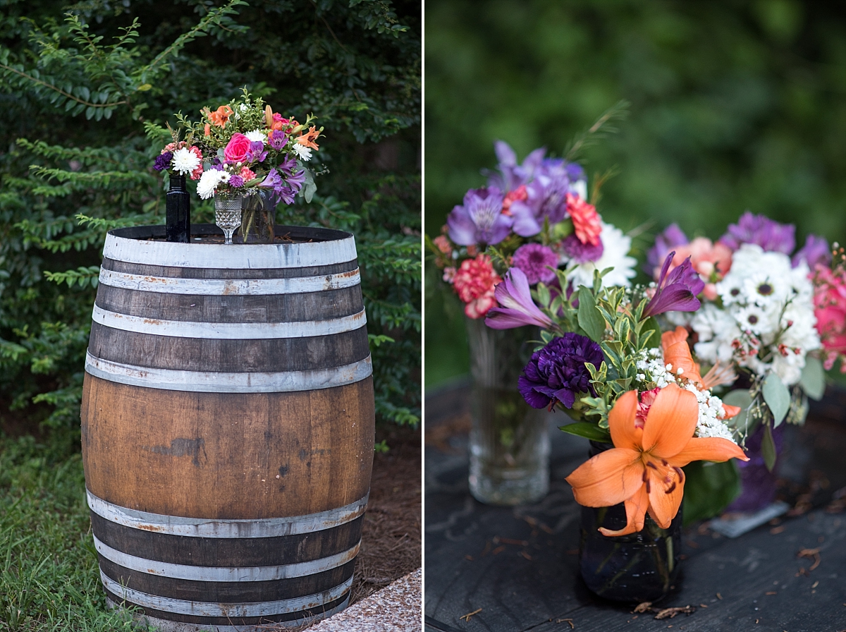 Flirty and fun orange purple and pink flower arrangements atop whiskey barrell