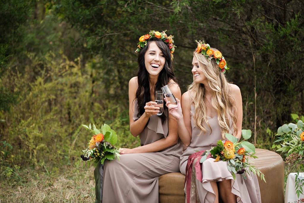 Bridesmaids laughing and drinking cocktails